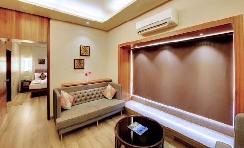 a waiting room with a couch and a large screen at SANKAMA The Boutique Hotel in Dāvangere