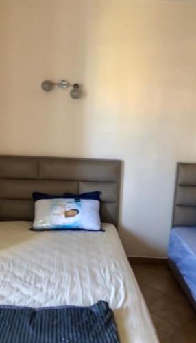 a bedroom with a bed with a pillow on it at Appartement Kabila Vista à 10min à pied de la plage in Marina Smir