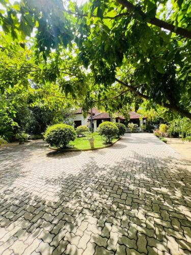 a cobblestone street in front of a house at Krishan Villa in Negombo