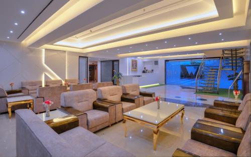 a living room with a couch and a table at Wingston A TreeHouse Hotel, Mathura in Mathura