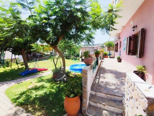 a house with a tree and a swimming pool at Η μαγική Εdem ένας μέρος χαλαρωσης in Grammatiko