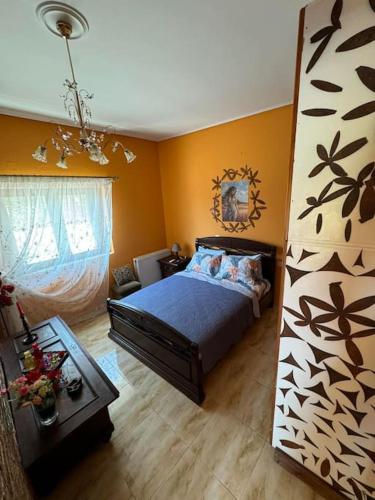 a bedroom with a bed and a living room at Η μαγική Εdem ένας μέρος χαλαρωσης in Grammatiko