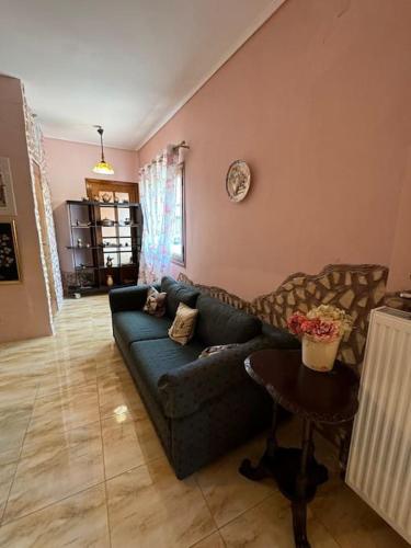 a living room with a blue couch and a table at Η μαγική Εdem ένας μέρος χαλαρωσης in Grammatiko