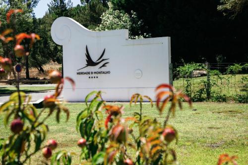 a sign for a park with flowers in the foreground at Herdade de Montalvo - Comporta in Comporta