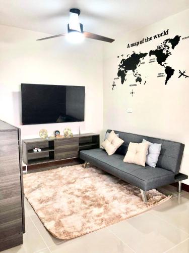 a living room with a couch and a flat screen tv at Luxurious Deluxe Apartment - EhubStay Mactan Cebu - Saekyung Condo Looc in Lo-oc