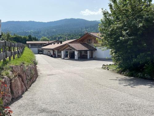 a road in front of a building with a fence at B&B Longanorbait in Folgaria