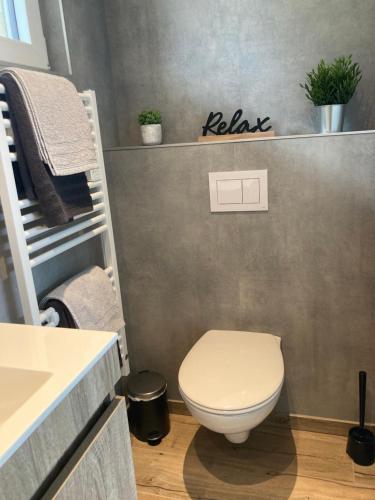 a bathroom with a toilet and a sink at Ô Secret du Wérihay in Spa
