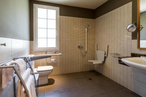 a bathroom with a shower and a toilet and a sink at Parador de Vic-Sau in Tavernoles