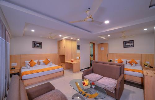 a hotel room with a bed and a living room at Wingston A TreeHouse Hotel, Goverdhan in Govardhan