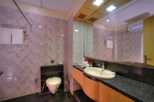 a bathroom with a sink and a toilet at Wingston A TreeHouse Hotel, Goverdhan in Govardhan