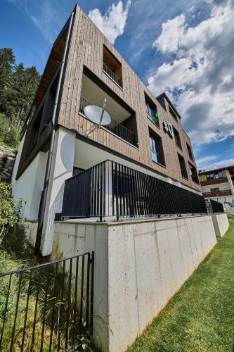 a building with a balcony on the side of it at sGmiatli – Dein Hideaway Apartment in Kappl