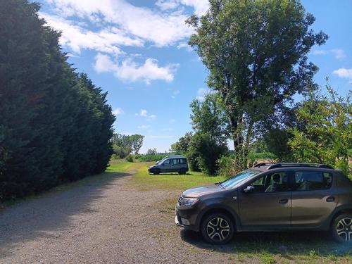 a car parked on the side of a dirt road at Le Moulin du Comte in Bourrouillan