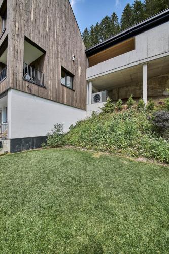 an external view of a building with a grass yard at sGmiatli – Dein Hideaway Apartment in Kappl