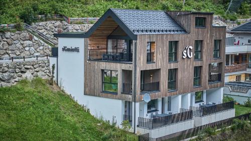 a house on a hill with a wooden facade at sGmiatli – Dein Hideaway Apartment in Kappl