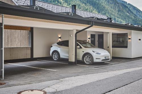 a white car is parked in a garage at sGmiatli – Dein Hideaway Apartment in Kappl