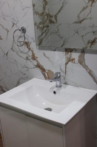 a white sink in a bathroom with a mirror at Park Royale Hotel in Kolkata