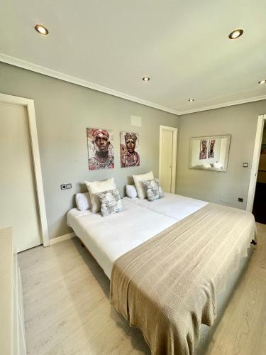 a bedroom with a large white bed with two pillows at La Casita de Alcabre in Vigo