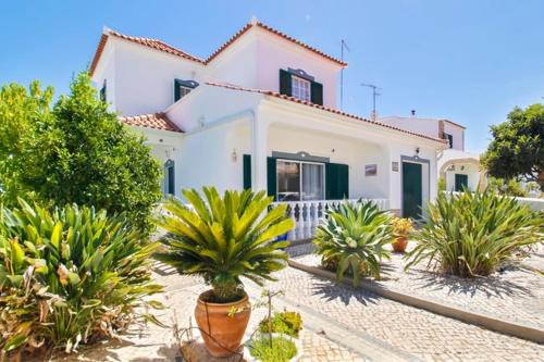 a white house with plants in front of it at Alcaria Grand House in Altura