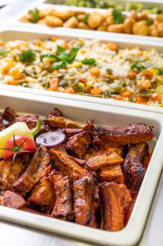 three trays filled with different types of food on a table at Vulkán Wellness Hotel & Camping in Celldömölk