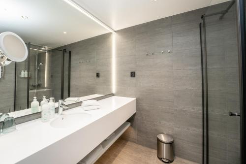 a bathroom with a sink and a shower at Break Sokos Hotel Bomba in Nurmes
