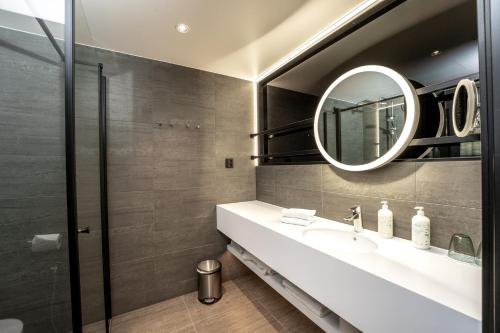 a bathroom with a sink and a mirror at Break Sokos Hotel Bomba in Nurmes