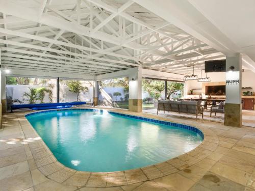 a large swimming pool in a large room with a ceiling at Nadora's Rest in Kirkwood