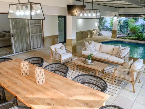 a patio with a table and chairs and a pool at Nadora's Rest in Kirkwood