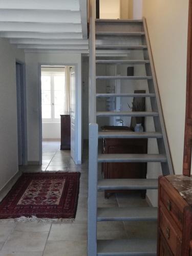 a metal staircase in a room with a living room at Château MontPlaisir charming b&b in Provence in Valréas