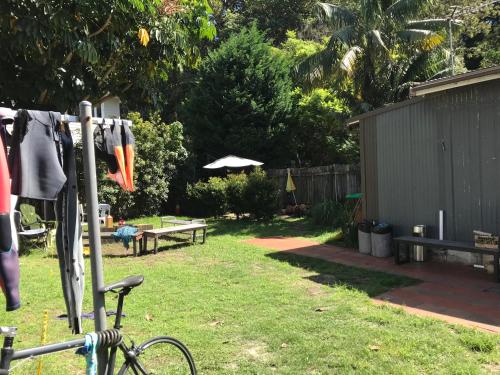 a bike parked in a yard with a picnic table at Manly Bunkhouse in Sydney