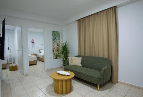 a living room with a green couch and a table at casa NEFELI in Karteros