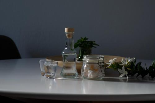 a bottle and two glasses on a table at casa NEFELI in Karteros