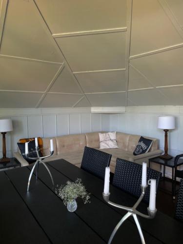 a living room with a couch and a table at Summer chalet in the heart of Riga in Rīga