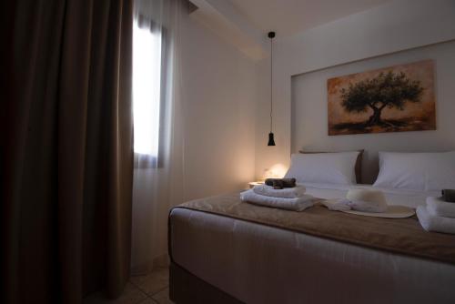 a bedroom with a bed with towels on it at casa NEFELI in Karteros