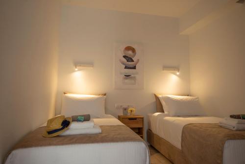 a hotel room with two beds and a picture on the wall at casa NEFELI in Karteros