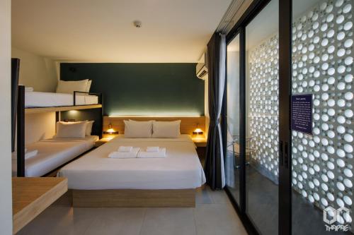 two beds in a room with two bunk beds at ON Thapae Gate Chiangmai in Chiang Mai