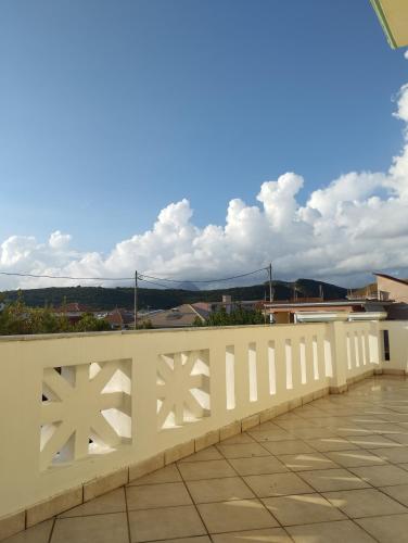 a white fence with a view of a city at Splantza Apartments in Ammoudia