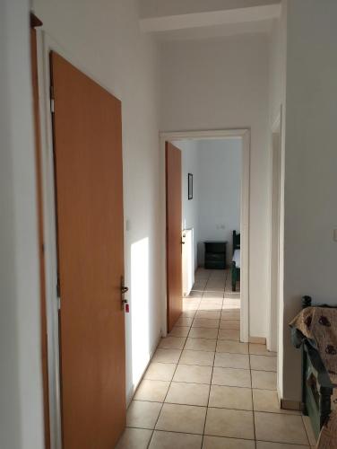 a hallway with two doors and a tile floor at Splantza Apartments in Ammoudia