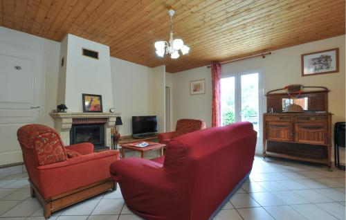 a living room with red chairs and a fireplace at Amazing Home In Saint-Andre-Les-Alpes in Saint-André-les-Alpes