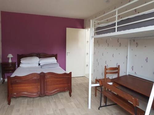 a bedroom with a bed and a loft bed at Chez Alex in Saint-Juéry