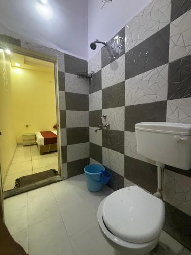 a bathroom with a toilet and a sink and a shower at Dream Ashoka Homestay in Ujjain
