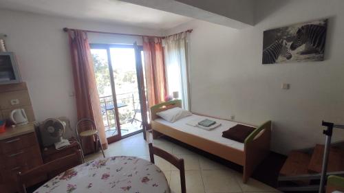 a small room with a bed and a window at Apartments Villa Ypsilon in Sveta Nedelja