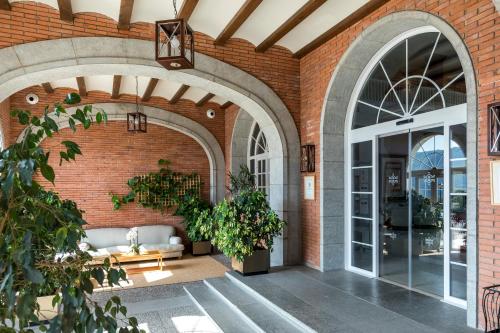 an entrance to a brick building with an open door at Parador de Vic-Sau in Tavernoles