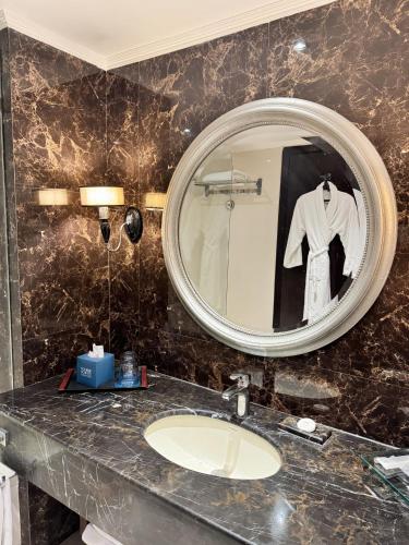 a bathroom with a sink and a mirror at Four Points by Sheraton Lahore in Lahore