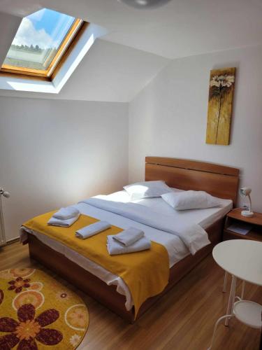 a bedroom with a bed with towels on it at Casa Marian in Buşteni