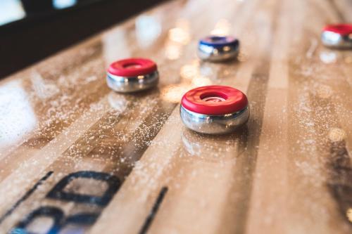 a group of red and silver knobs on a wooden table at Quality Hotel The Mill in Malmö