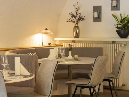 a dining room with a white table and chairs at Hotel Lekker in Neumagen-Dhron