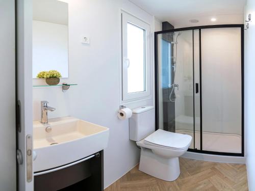 a bathroom with a sink and a toilet and a shower at Camping Almissa in Omiš