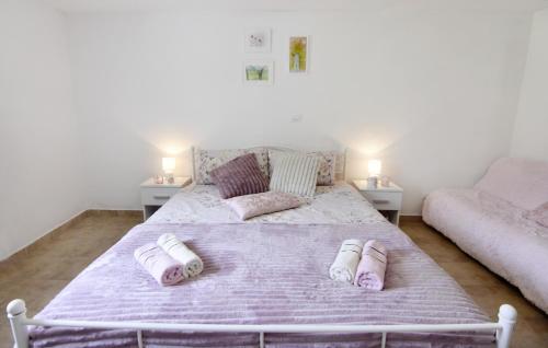 a bedroom with a bed with slippers on it at Vila Vesna in Grožnjan