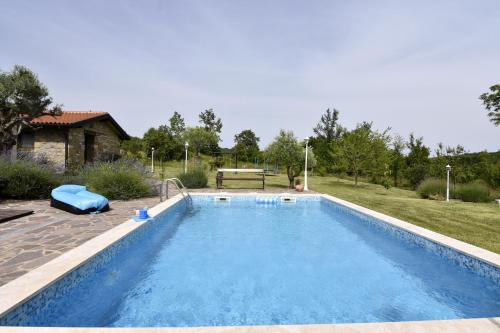 a large swimming pool in a yard with a house at Vila Vesna in Grožnjan
