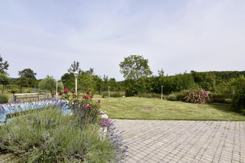 a garden with a fountain and flowers in a park at Vila Vesna in Grožnjan